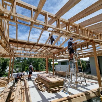 Carpenters framing a roof truss structure on a Brisbane build